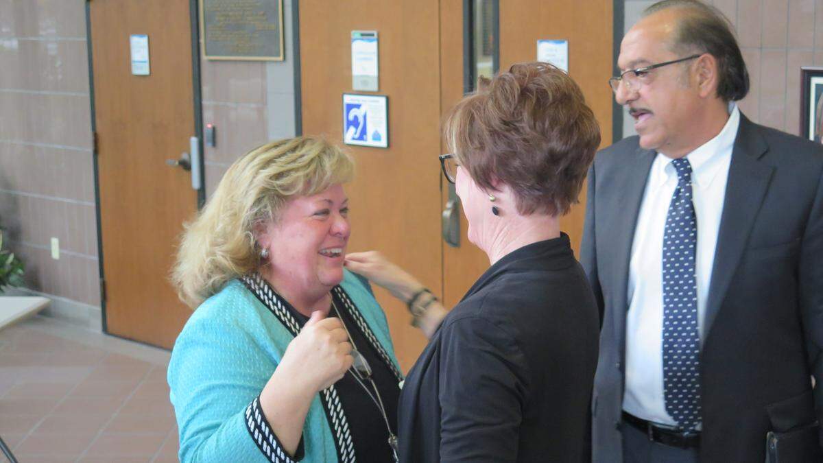 Cheri Coryea (left) hugs Manatee County staff members moments after she was officially appointed to serve as acting county administrator following Ed Hunzeker’s retirement on Feb. 26.