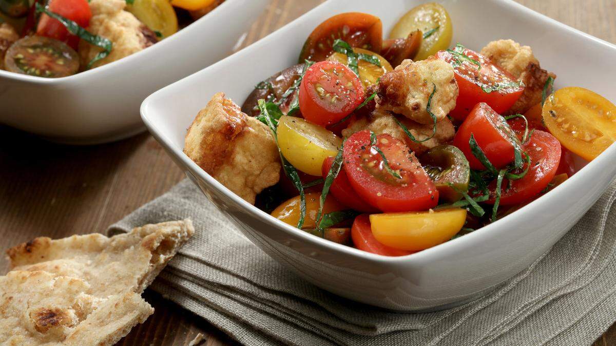 Colorful tomatoes offer a fresh, cool contrast to cubes of fried halloumi. TNS