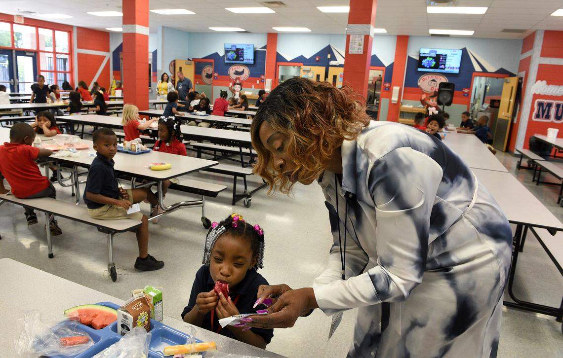 Vanessa Goldsmith, Manatee Elementary School’s Graduation Enhancement Technician, helps her granddaughter, Toniyah McDaniels, 5, with her lunch in the cafeteria.