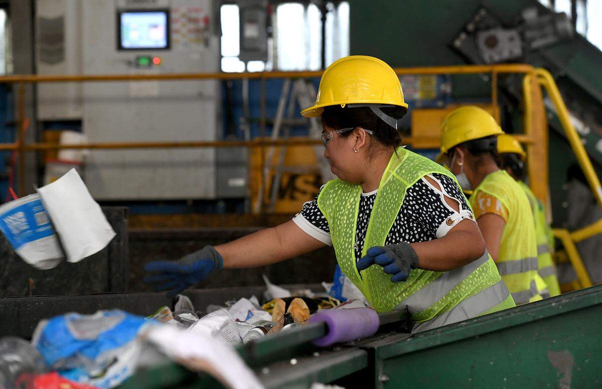 Workers sort through recycling at Waste Pro at 7921 15th Street East, Sarasota.