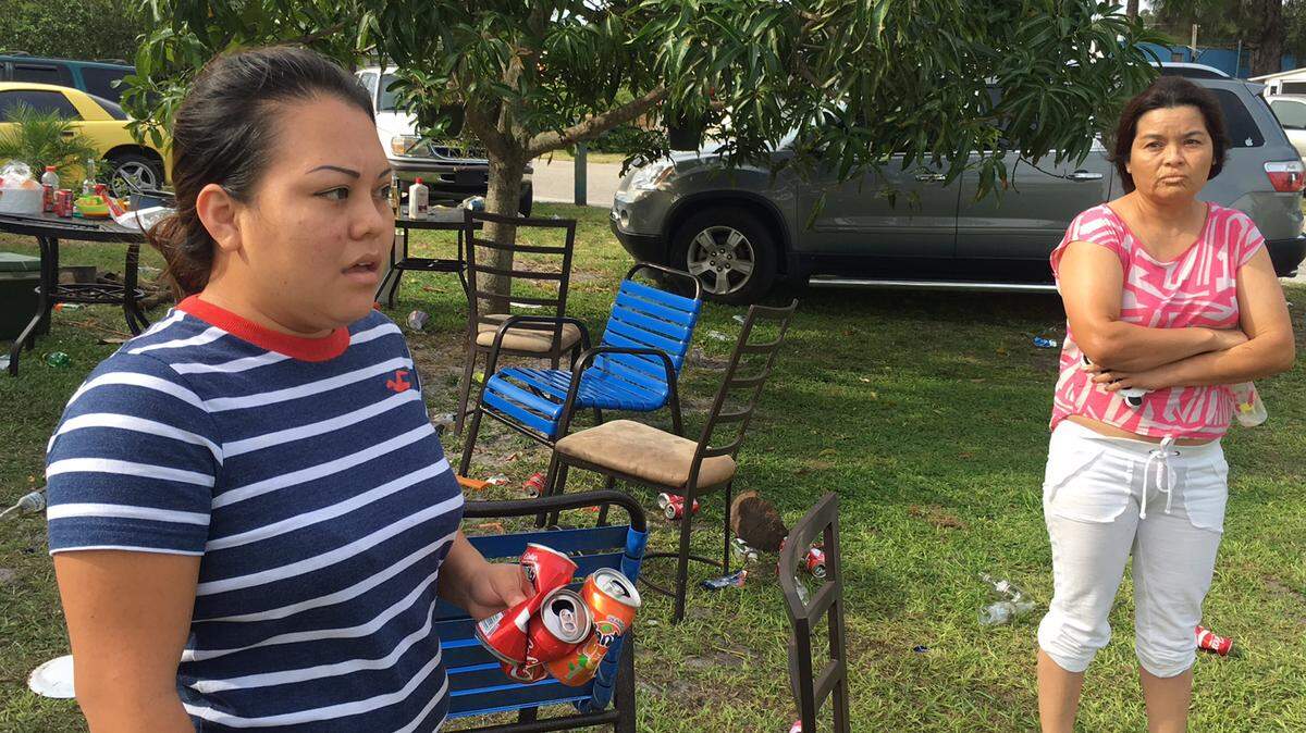 Esbeyda Agustin, left, her mother and Agustin's children live across the street from where a fatal shooting occurred Saturday at the corner of 23rd Street East and Sixth Avenue Drive East in East Bradenton. 
 RICHARD DYMOND/Bradenton Herald