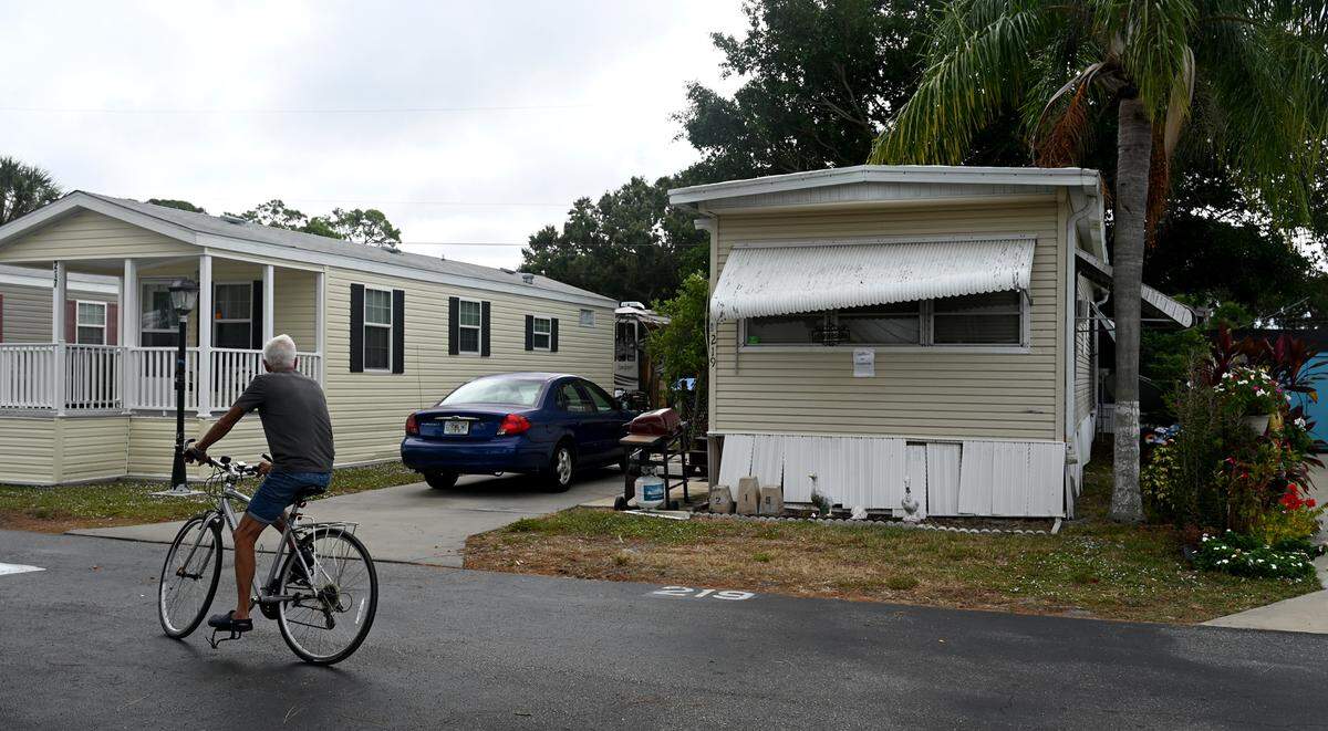 A cyclist glances at the home where Patricia Matejcek and Sean Harrison, Sr. were found dead in the Arbor Terrace RV Park in Bradenton on Friday, Nov. 10. Thomas Matejcek, Patricia’s son, is facing two counts of second-degree murder in the double-homicide case.