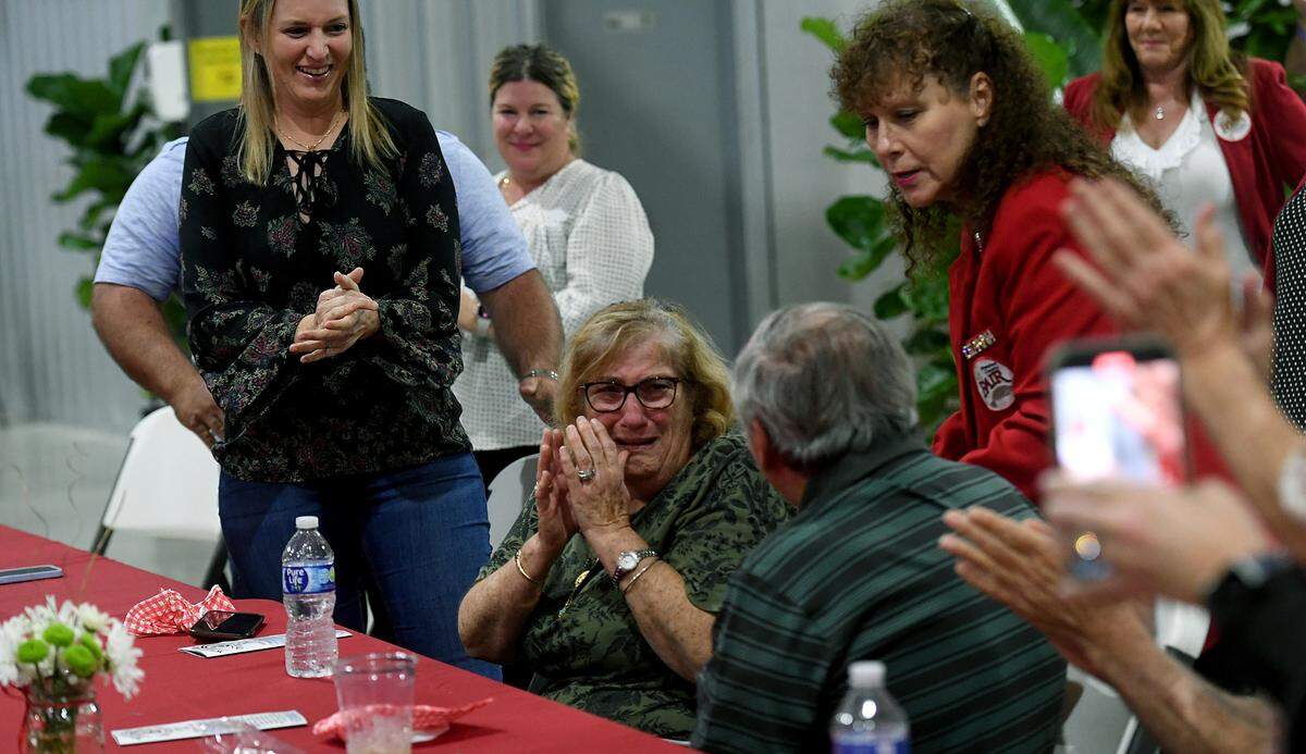 Popi and Manny Ameres, founders of Popi’s restaurants in Bradenton-Sarasota area, react as their names are called out as the Manatee County Fair’s distinguished citizens on Jan. 5, 2023.