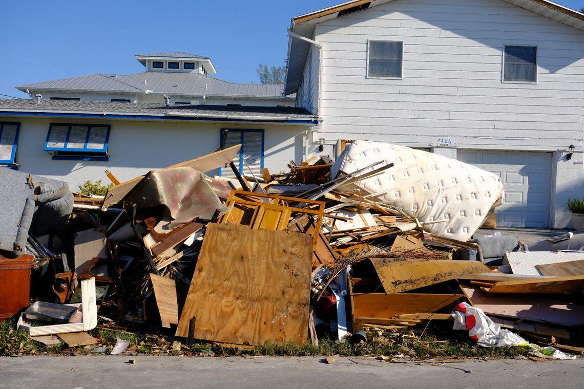 Wreckage is stacked in front of an Anna Maria Island home after Hurricane Milton.