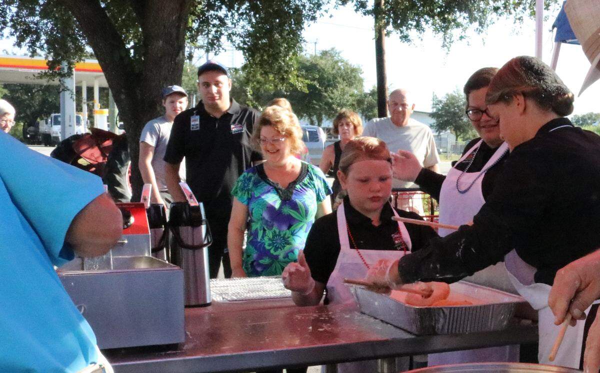 Customers line up for free doughnuts Wednesday during a celebration to mark the opening of the original Detwiler’s Farm Market 10 years ago at 6000 Palmer Blvd., Sarasota.