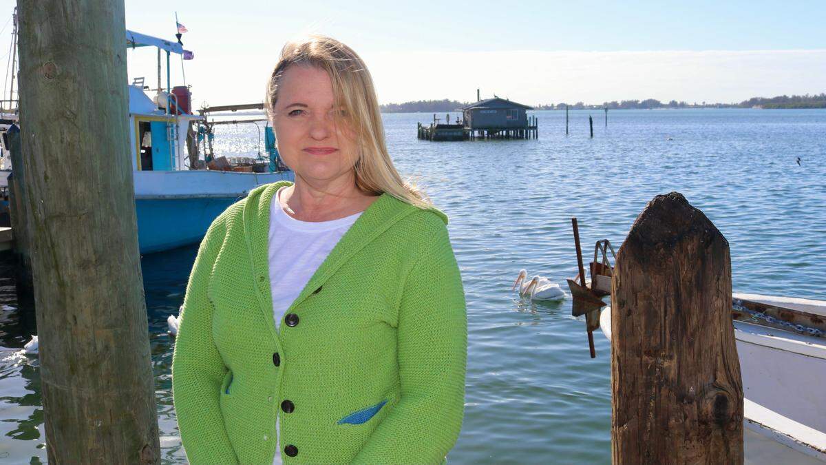12/30/2020--Karen Bell is leading the fight to save the Guthrie net camp, shown behind her. The Florida Department of Environmental Protection has ordered that it be removed by Jan. 24.