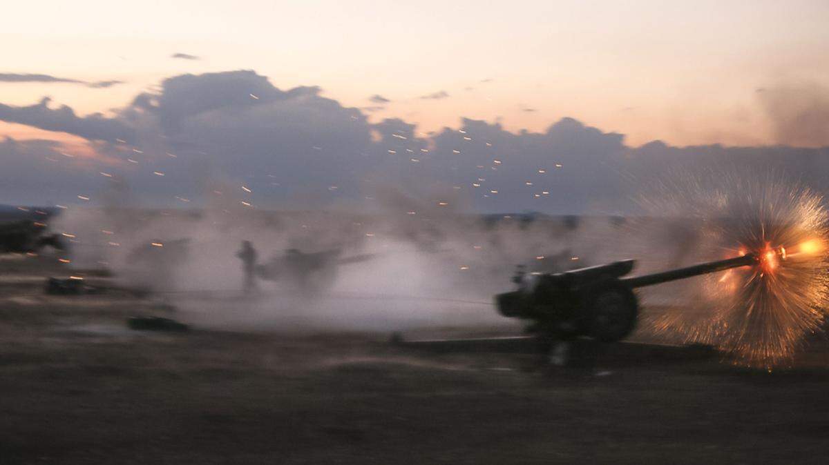 In this photo taken on Wednesday, Oct. 7, 2015, Syrian army howitzers fire near the village of Morek in Syria. The Syrian army has launched an offensive this week in central and northwestern Syria aided by Russian airstrikes. (AP Photo/Alexander Kots, Komsomolskaya Pravda, Photo via AP)
