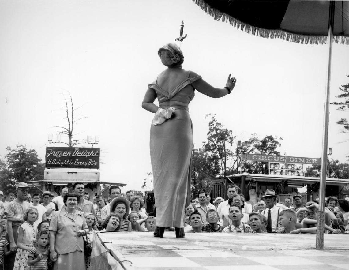 A 1950s photo of a sideshow sword swallower.