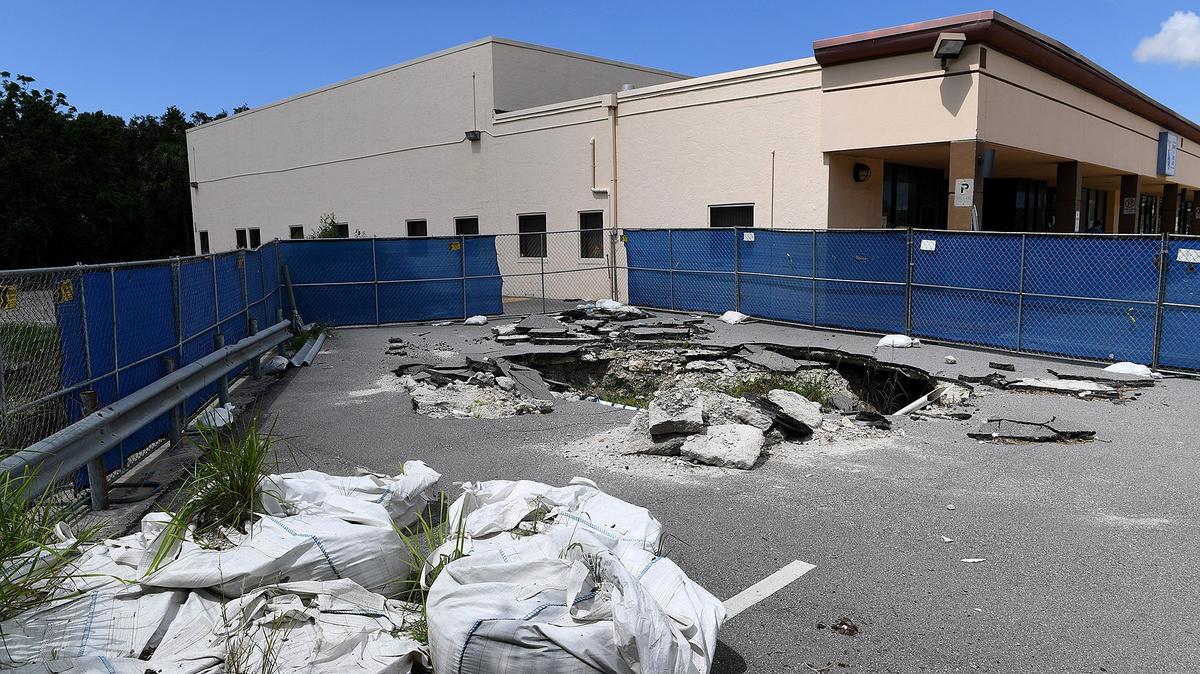 The sinkholes in Cortez Plaza continue to grow as businesses carry on as usual around fenced off areas.