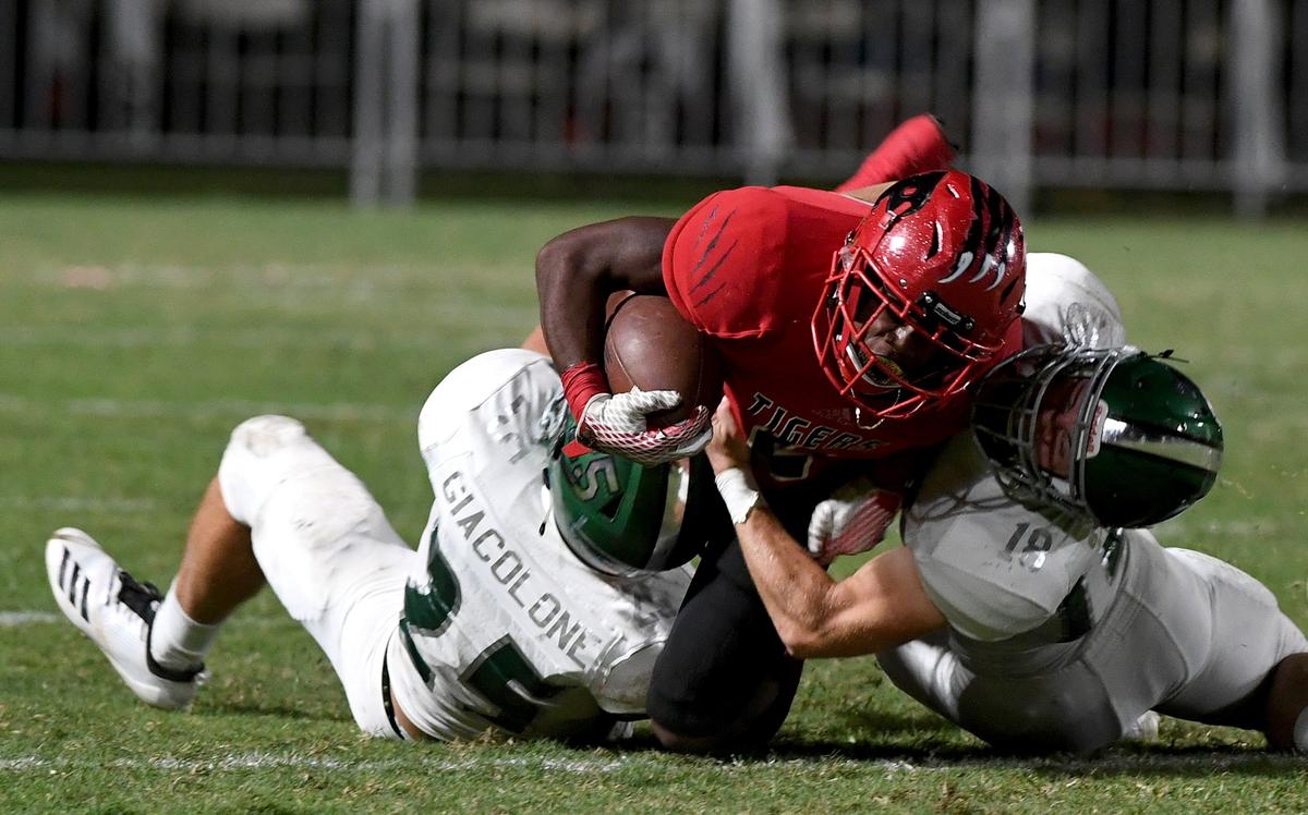 Palmetto’s Corrian Brown lands on Venice players with the ball at the Palmetto vs. Venice game at Palmetto Friday night.
