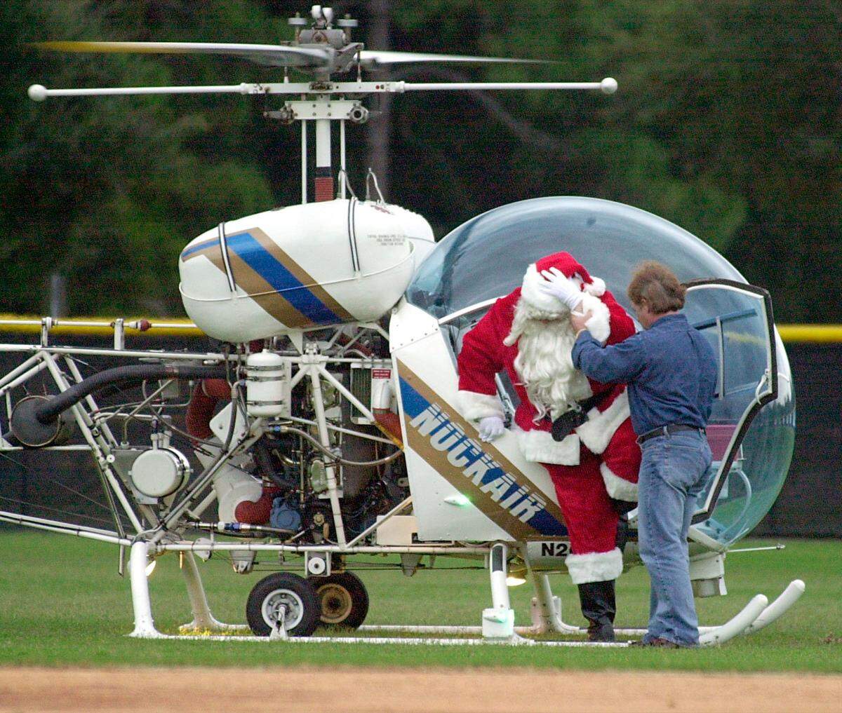 BRADENTON -- 12/14/2002 -- Santa Claus holds his signature hat as he arrives at G.T. Bray park for “A Night Before Christmas” festivities. This is Santa’s 14th trip to Bradenton via helicopter. Herald photo by Paul Gonzalez Videla.