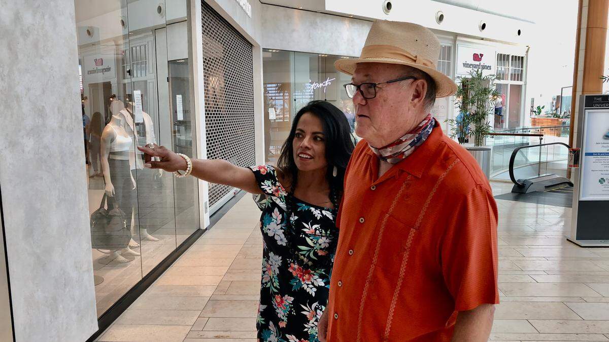 After being closed for 47 days because of the coronavirus pandemic, the Mall at University Town Center reopened at 11 a.m. Wednesday. Shown above are shoppers Vann and Marita Herring.