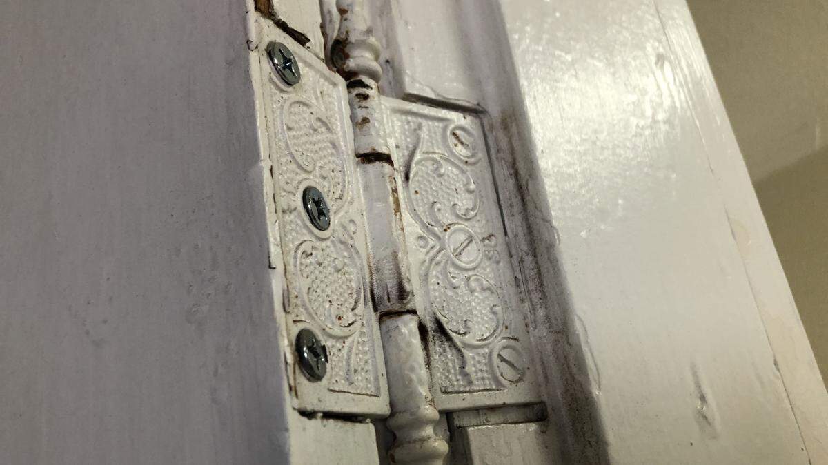 Detail of a door hinge in the Iron Block building, 528 12th St. W., which is on the market for $1.1 million. During its more than 100-year history, the building has housed a candy store, a cigar shop, tailor shop, shoe repair business, legal offices and more. It is called Iron Block because of its decorative pressed metal facade.