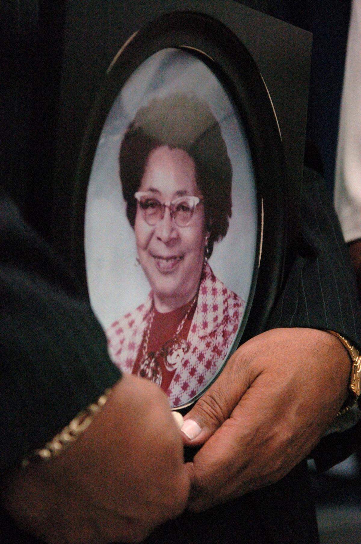 John Westley Williams, the son of Annie Lucy Williams, holds a portrait of his mother after a dedication for the Annie Lucy Williams Elementary School.