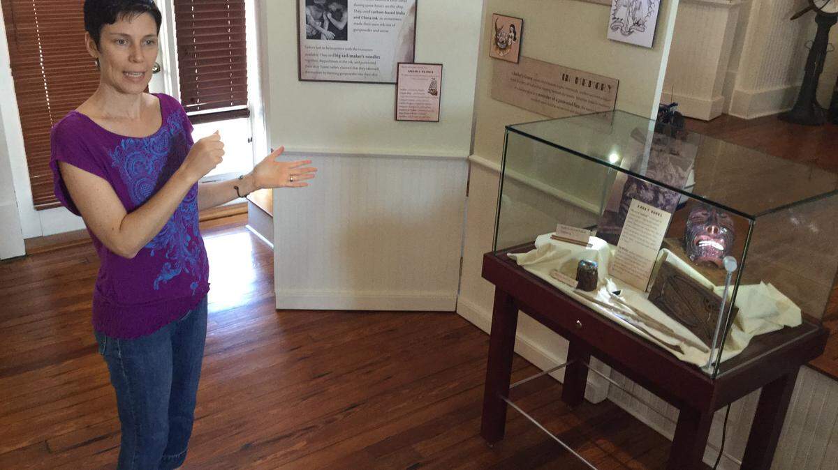 Florida Maritime Museum Curator Amara Nash explains some supersticious tattoos sailors across the centuries believed to have kept them safe from all sorts of sea monsters and bad luck. The Sailors & Supersticions exhibit opened Oct. 8 at the museum located in the Historic Village of Cortez. MARK YOUNG/Bradenton Herald