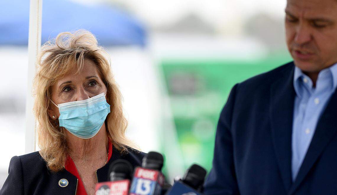 02/17/21--Manatee Commissioner Vanessa Baugh listens as Gov. Ron DeSantis hosts a press conference at the Lakewood Ranch pop-up COVID-19 vaccination site aimed at inoculating more senior citizens. DeSantis faced criticism over the site, which stands to vaccinate some of Manatee’s wealthiest residents.