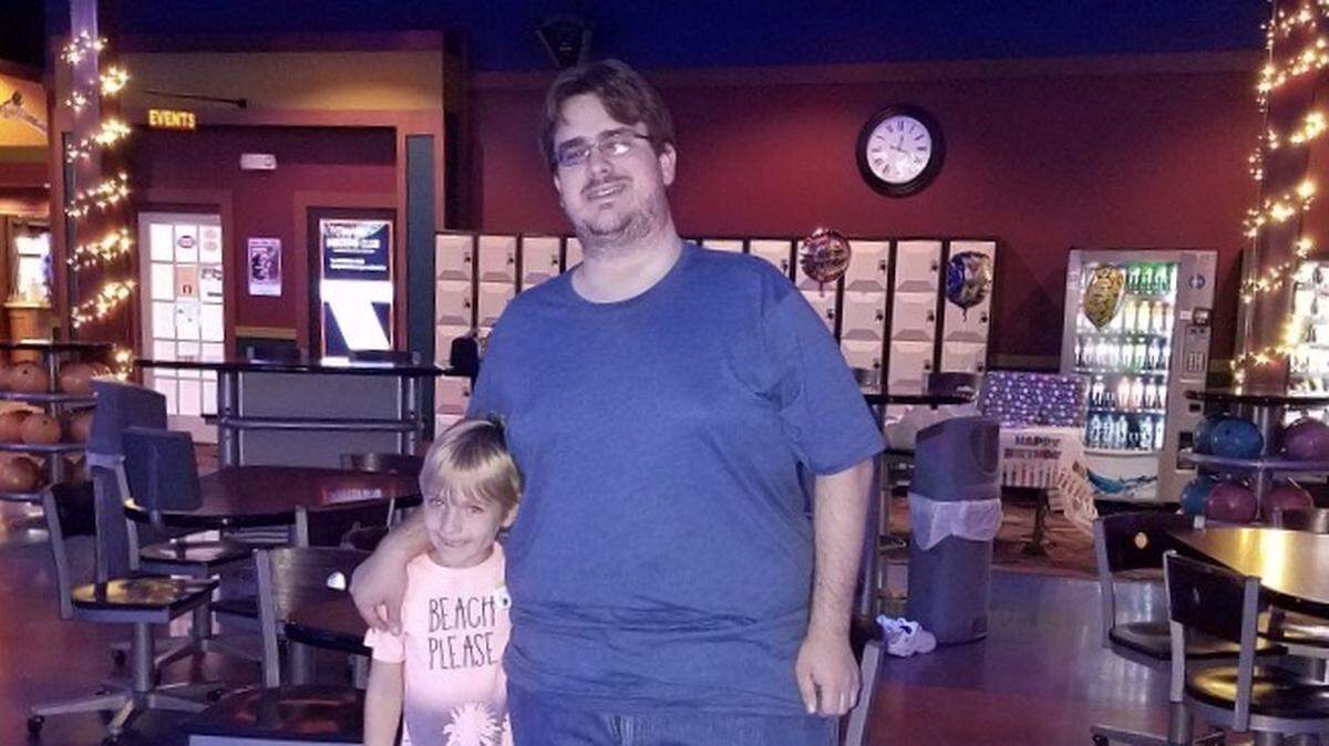 Nick Van Glahn is shown with a young family member at a bowling alley.