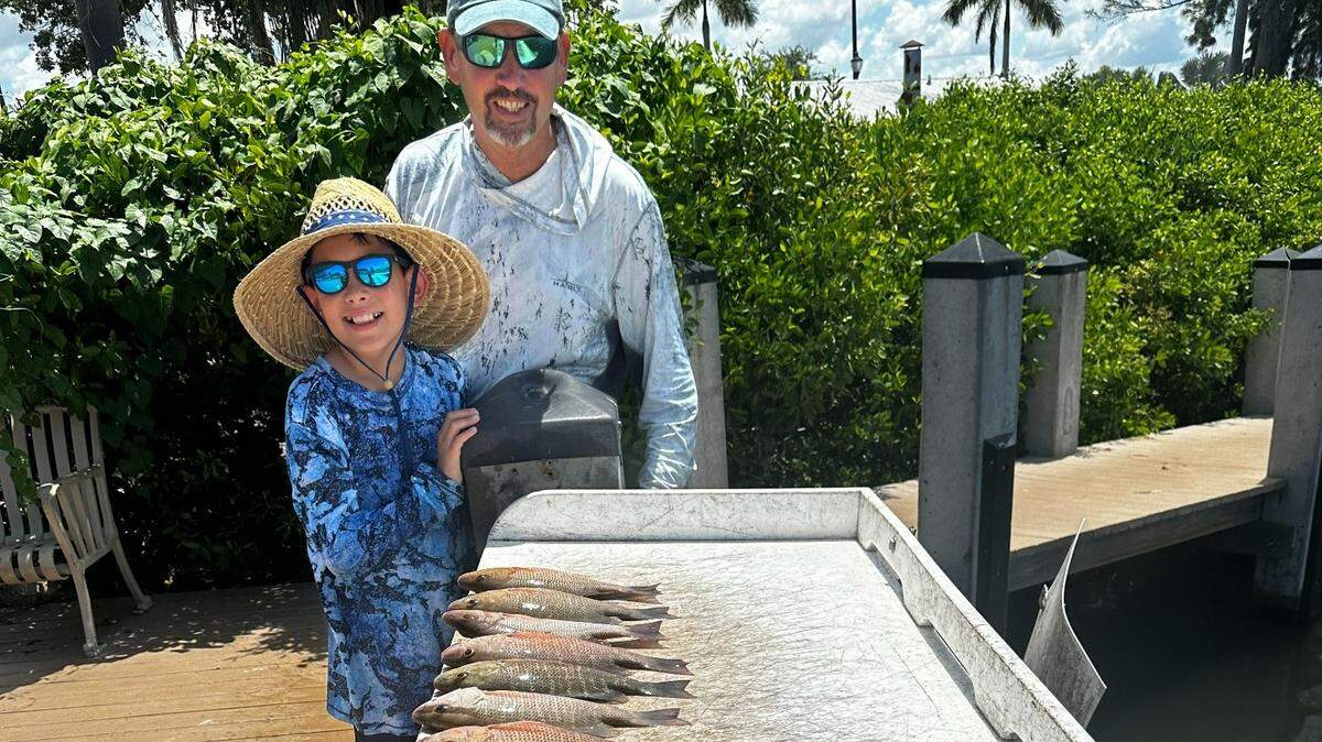 Charlie Camp and Collin, 11, with mangrove snapper limit and trout caught on Friday, Aug. 4, with Capt. John Gunter on Tampa Bay.