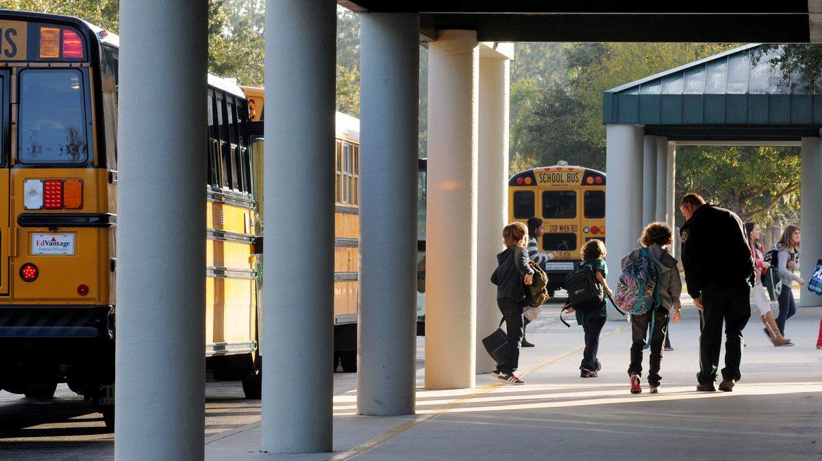 Students exit school buses at Braden River Middle School in this file photo.