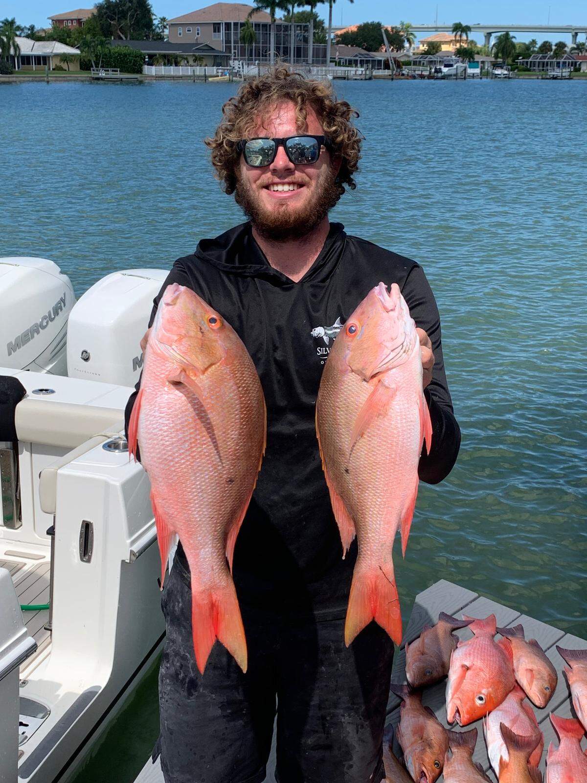 Sam Weller with a pair of mutton snapper from a successful overnight offshore trip Oct. 12.
