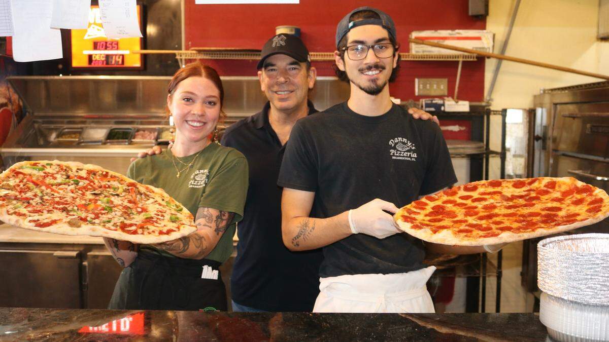 Joanie and Danny Fernandez, the original owners of Danny’s Pizzeria, 7220 Manatee Ave. W., Bradenton, have come out of retirement to resume ownership of the restaurant. Shown above Dec. 14, 2022, are (from left) Meagan Florian, Danny Fernandez and Caleb Mena.