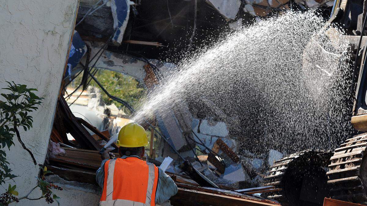 Demolition of the Manatee Players building on the riverfront in downtown Bradenton is underway. Rex Chupp sprays water on the building as it's torn down.TIFFANY TOMPKINS-CONDIE/Bradenton Herald