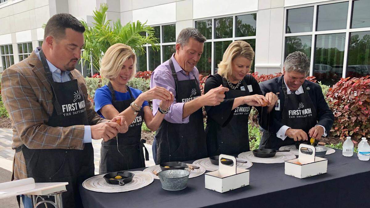 7/15/2021--Taking part in the egg-cracking ceremony in July at the new corporate headquarters of Bradenton-based First Watch restaurants were, from left, Chris Tomasso, Sharon Hillstrom, George Kruse, Jacki Dezelski and Scott Hopes.