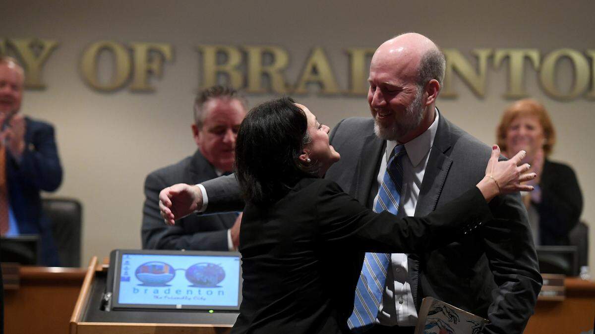 Lisa Gonzalez Moore hugs her husband, Fred Moore after being sworn in as Councilwoman for Ward 4 at the Bradenton City Council’s swearing in ceremony during a special session on January 3, 2023.
