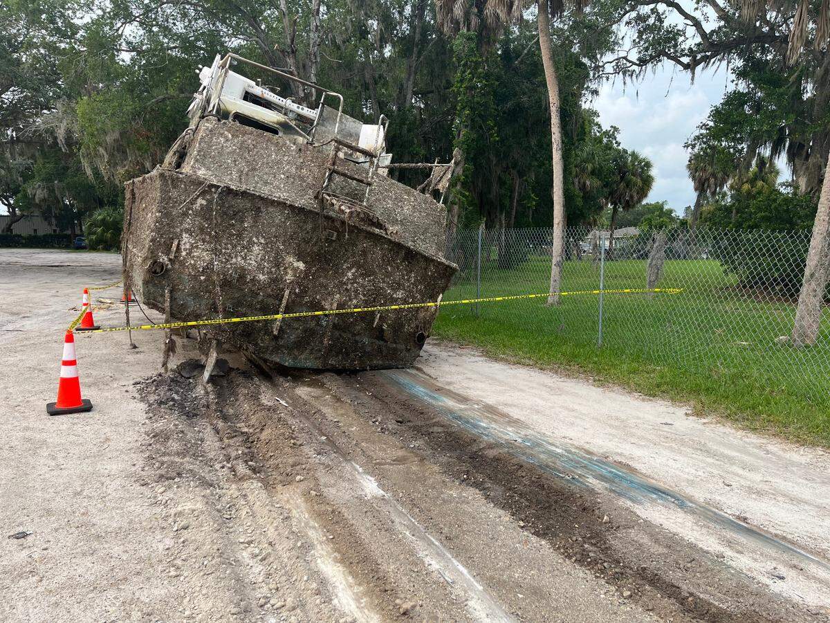Rear-view of the 40’ Concord Yacht pulled from the Manatee River near the Green Bridge. A blue paint smear from the boat was imprinted on the dirt lot across from Riverside Boat Ramp where it was parked before being taken to the landfill.