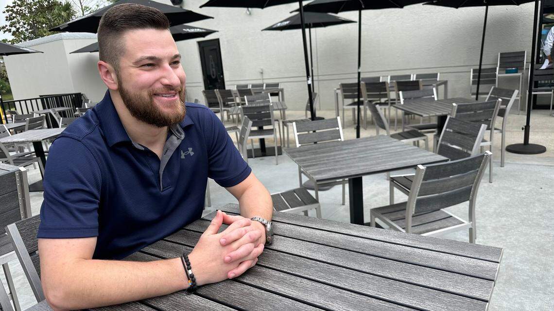 Jake Francis, bar manager for The Greyson, sits at a table on the patio. The restaurant is located at 11161 State Road 70 E., unit 100, Lakewood Ranch.