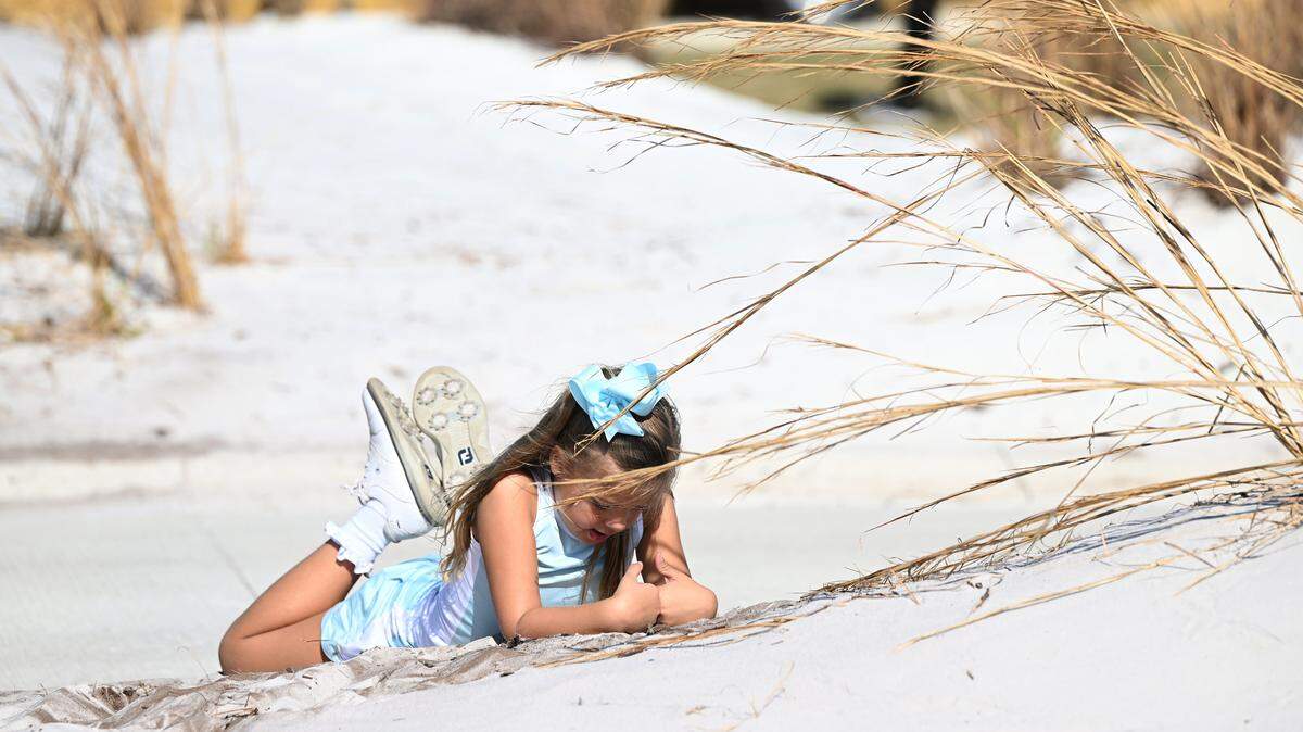 Brooke Turner, 6, daughter of developer David Turner, plays in the dunes of the newly-opened Soleta Golf Club in Myakka City.