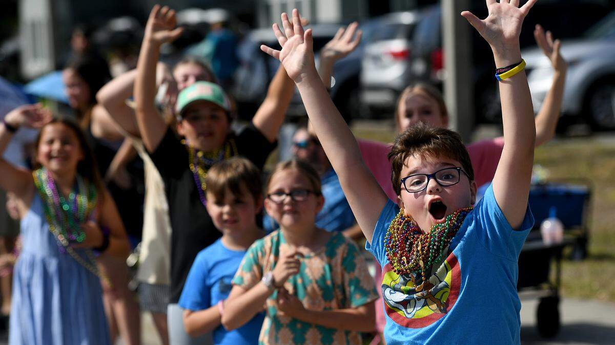 Children cheer and yell for beads during the Hernando DeSoto Historical Society’s Children’s Parade on Friday, April 7, 2023 in Palmetto.