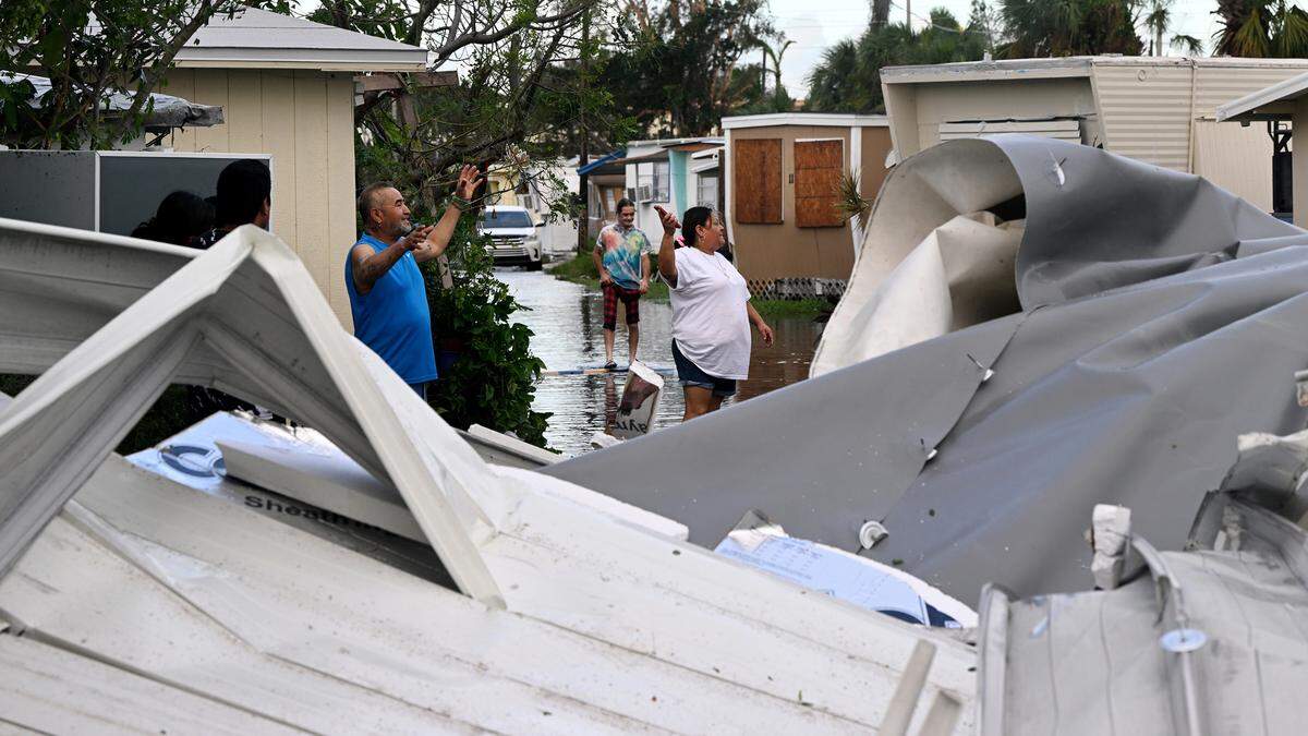 Residents of Luxor Mobile Home Park in Bradenton, Florida, survey the damage in the aftermath of Hurricane Milton on Oct. 10, 2024.