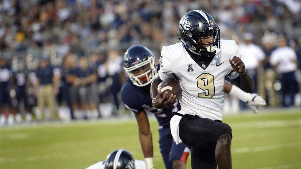 Central Florida running back Adrian Killins Jr. (9) runs the ball in for a touchdown during the first half of Thursday’s 56-17 victory against Connecticut.
