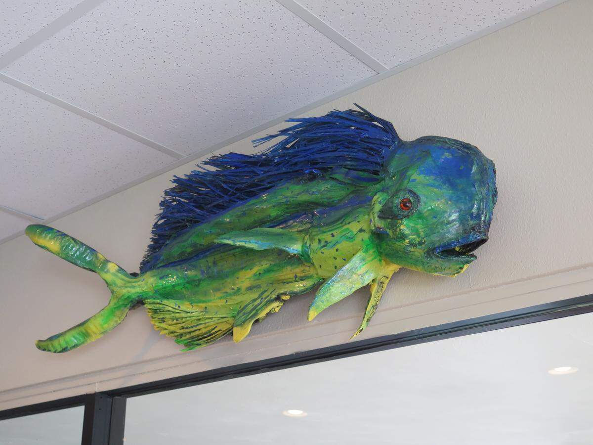 The Clam on 59th is decked out with local art. This piece was created by David Skaggs, using palm tree fronds and shells, according to restaurant owner Wesley Rose.