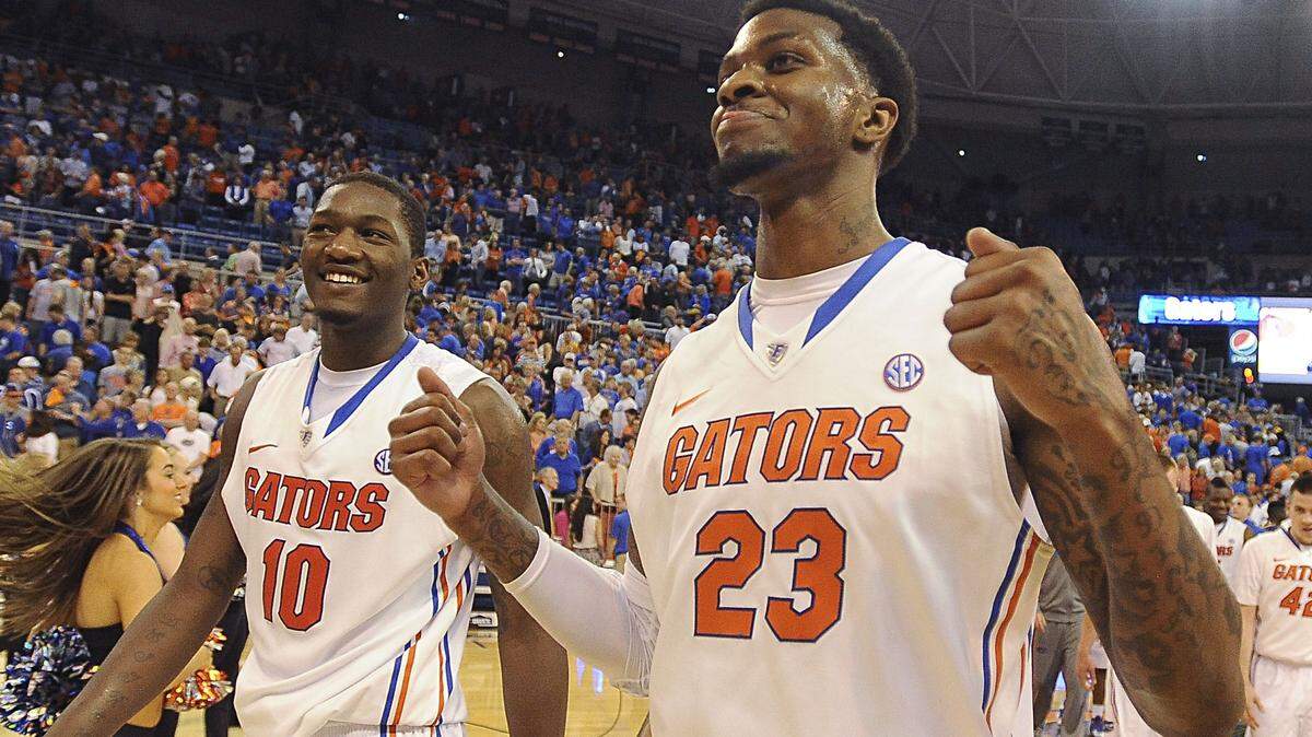Florida's Chris Walker (23) and Dorian Finney-Smith (10) come off the court with smiles after Florida defeated LSU 79-61 in an NCAA college basketball game Saturday, March 1, 2014, in Gainesville, Fla. (AP Photo/Phil Sandlin)