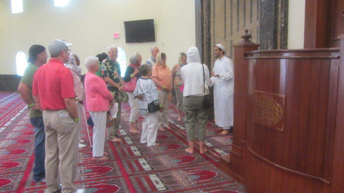Community members talk about Islam with an official from the Islamic Society of Sarasota and Bradenton during last year's International Food and Crafts Festival at the mosque on Lockwood Ridge Road. 
 PROVIDED PHOTO