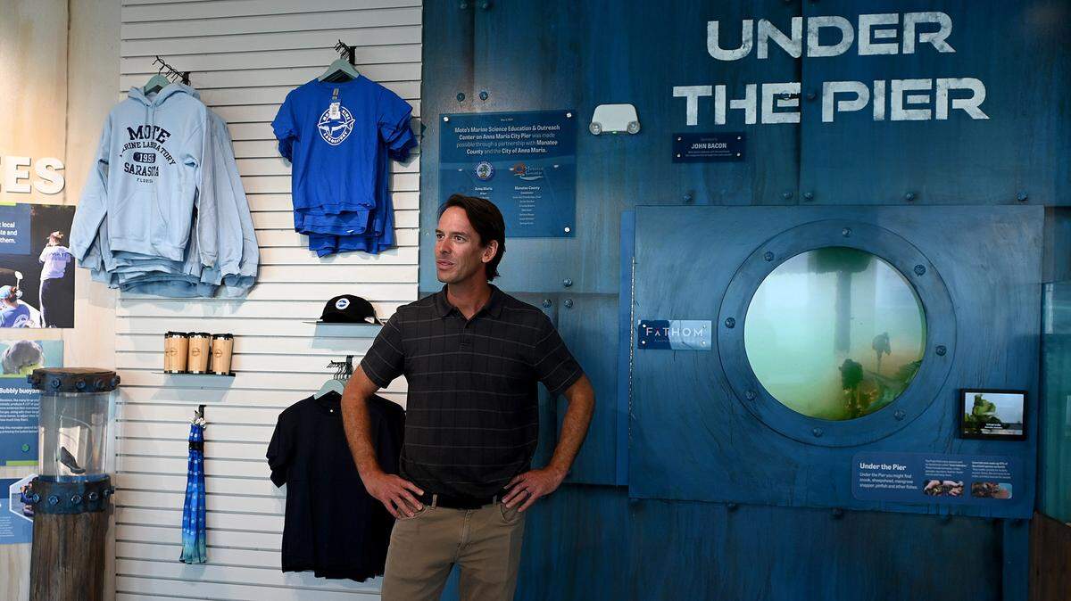 Evan Barniskis, Associate VP of Mote Marine Aquarium, points out features of one of the exhibits during a preview of the Mote Marine Laboratory & Aquarium which opens its Anna Maria outreach and education center this week on the Anna Maria Pier.