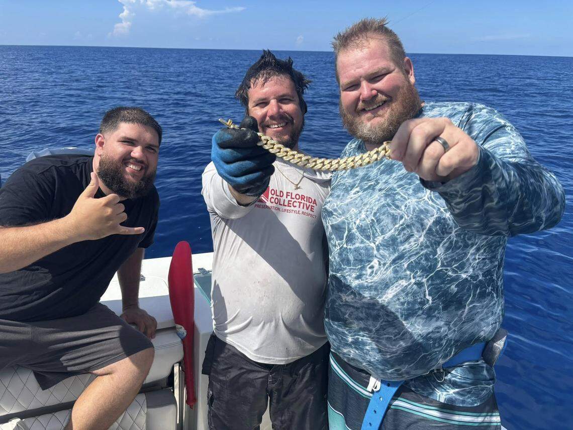 Tyler Feijoo, Dalton Conrad and Chad Tripp pose with a $25,000 18K gold Cuban link bracelet that they recovered from the bottom of the Gulf. 