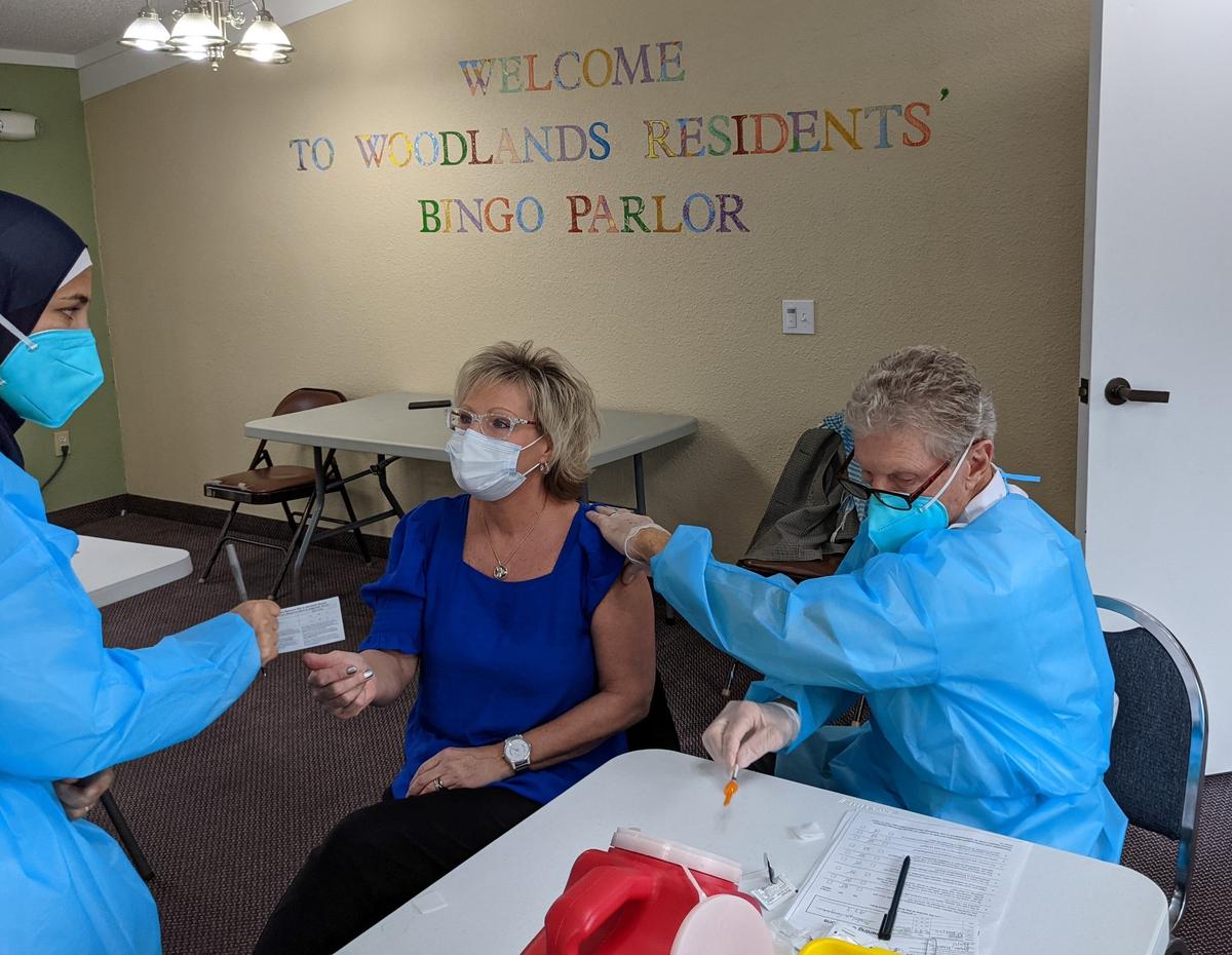 1/17/21--CVS Health staff administered the COVID-19 vaccine to 200 residents and staff of Woodlands Village, a Bradenton retirement community. The facility’s activities director, Deborah Hoffman, was among those to get the shot.