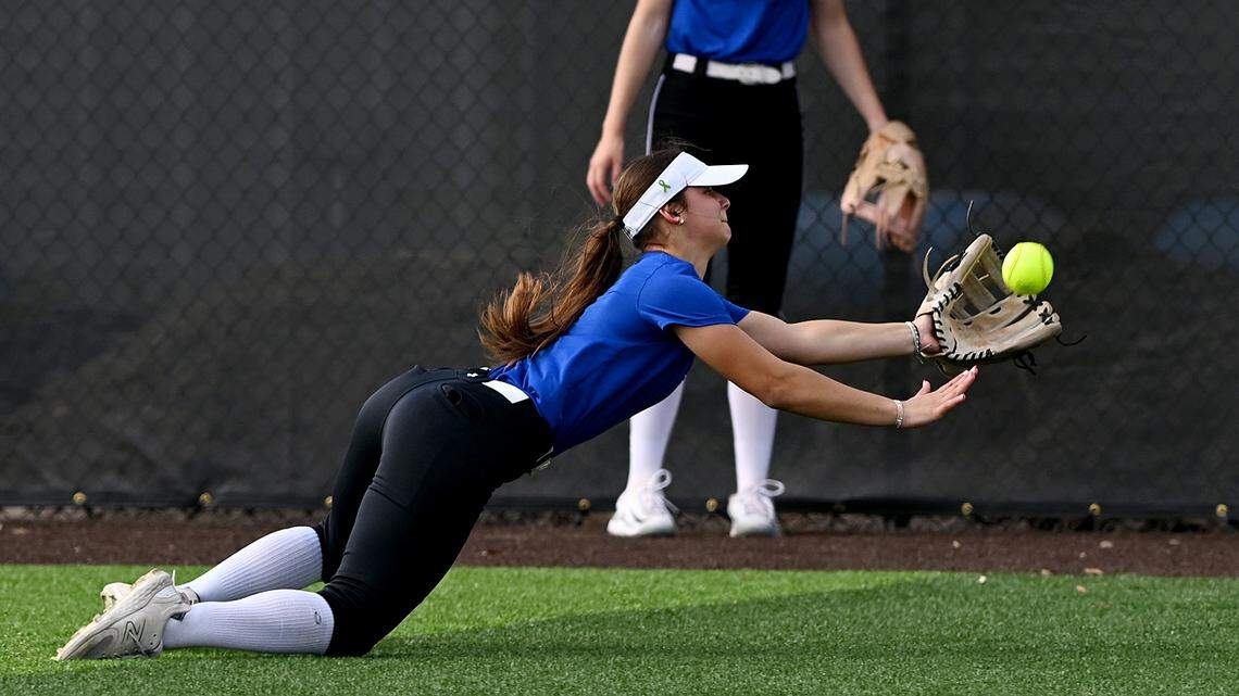 A softball recruit fields a ball in the outfield at IMG’s new softball facilities on Softball Prospect Day.