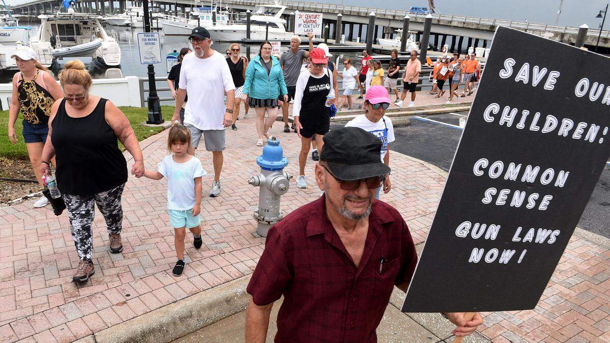 David Dean carries a sign during March For Our Futures, an anti-gun violence march and rally organized by Women’s Voices of Southwest Florida, marches from the Riverwalk splash park to Bradenton’s Historic Courthouse.