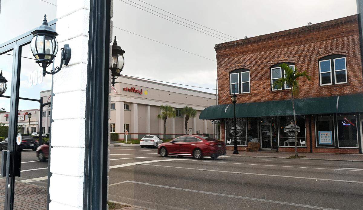 The Riverwalk expansion in downtown Bradenton connects shops, cultural venues, restaurants and bars. It also provides a picturesque way to walk, ride or scooter along the Manatee River. Central Cafe and the Farmhouse are reflected in a window across Manatee Avenue East.