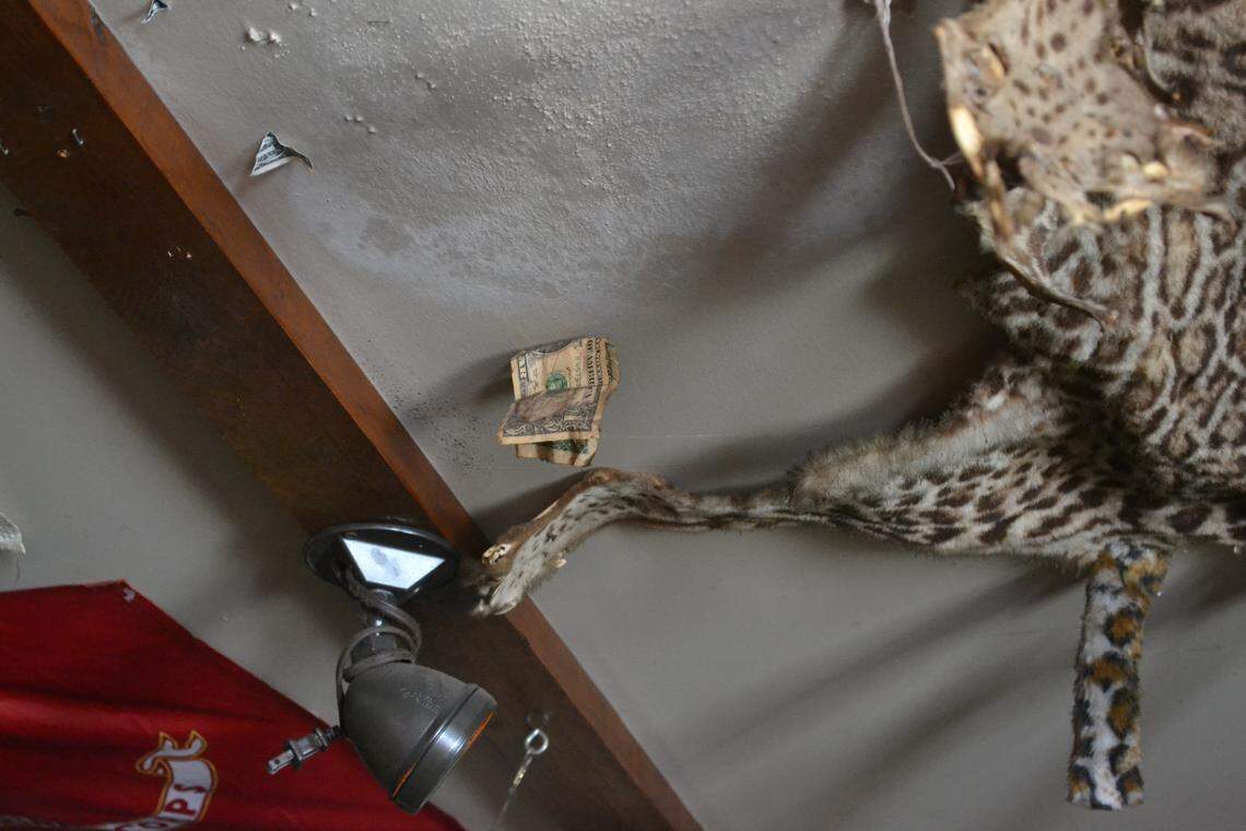 The first dollar bill that Tip Top Tavern made hangs near the entrance to the bar.