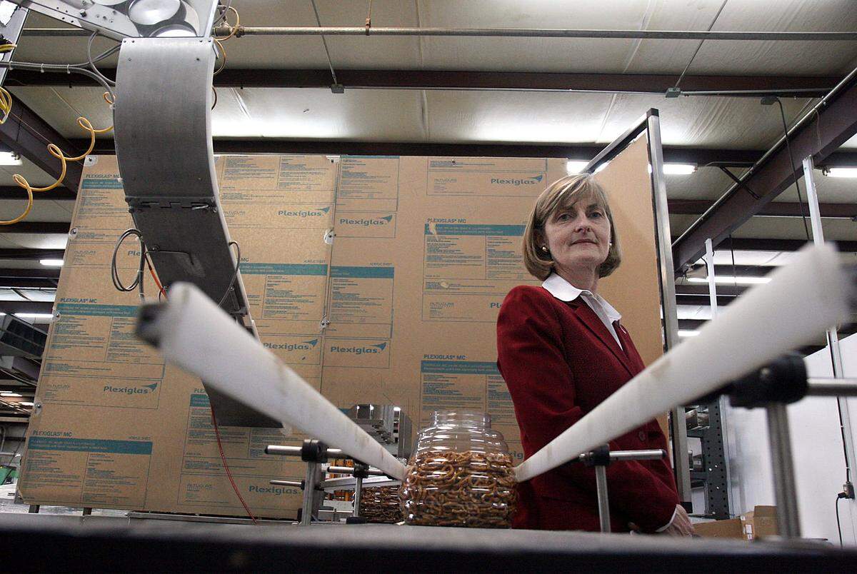 Among the Bradenton area businesses listed by CareerSource Suncoast as looking to fill jobs is New England Machinery. Shown above is Judith S. Nickse with a machine that puts the lids on pretzel containers.