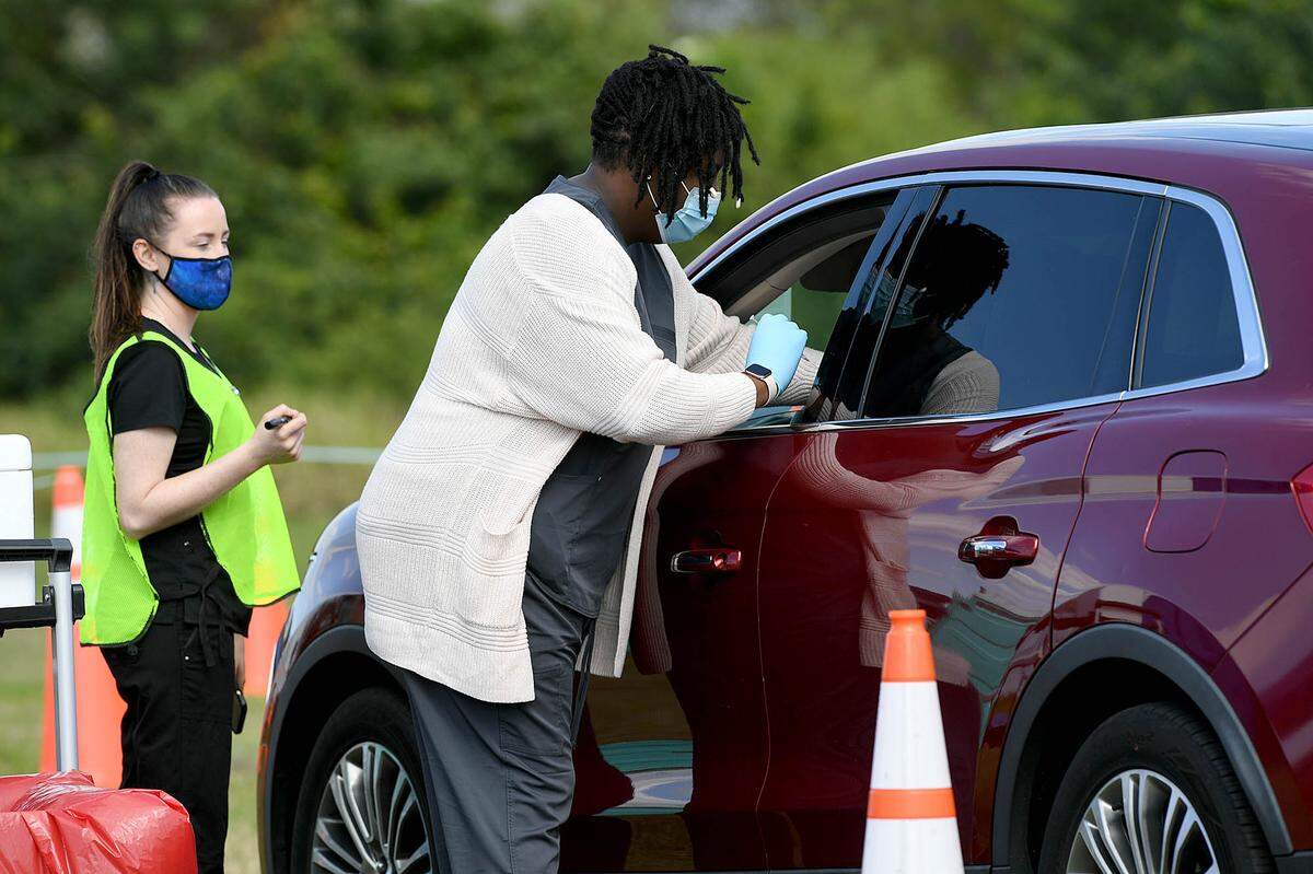 03/08/21--Starting March 15, Manatee is opening up access to the COVID-19 vaccine for those 60 or older as well as anyone with special medical conditions that make them vulnerable. In this Bradenton Herald file photo, health care professionals vaccinate people as they drive through a line at the Manatee County Public Safety Center in Bradenton on Monday.