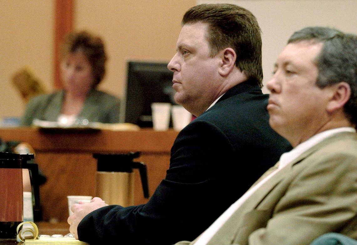 Defendant Joseph Smith, center, sits with his public defender, Adam Tebrugge, prior to waiving their closing argument, during the prosecution’s closing arguments on the seventh day of Smith’s trial at the Sarasota County Judicial Center in Sarasota, Fla., Wednesday, Nov. 16, 2005. Smith is charged in the abduction, rape and killing of 11-year-old Carlie Brucia in February 2004.