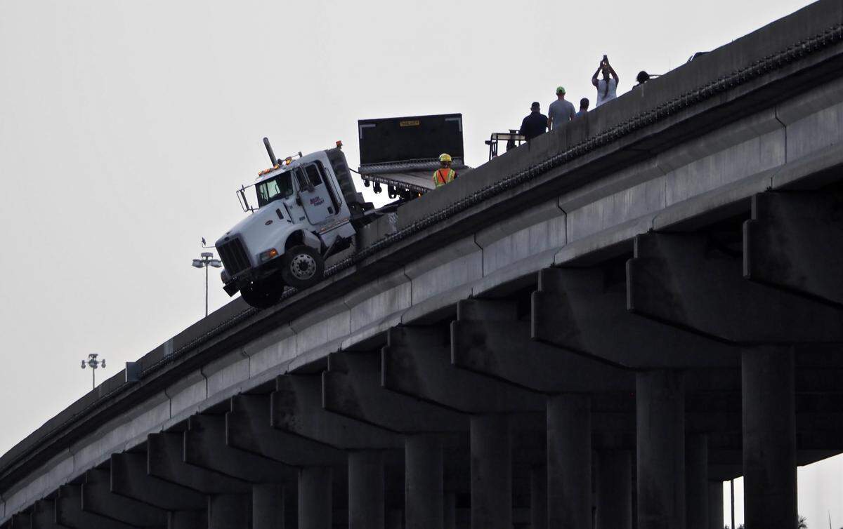 A semi truck was dangling over the Trooper JD Young Bridge early Friday morning. Northbound traffic on the bridge was shut down while crews worked to remove the truck. The driver made it out safely, according to Florida Highway Patrol. This view is from the south bank of the Manatee River.