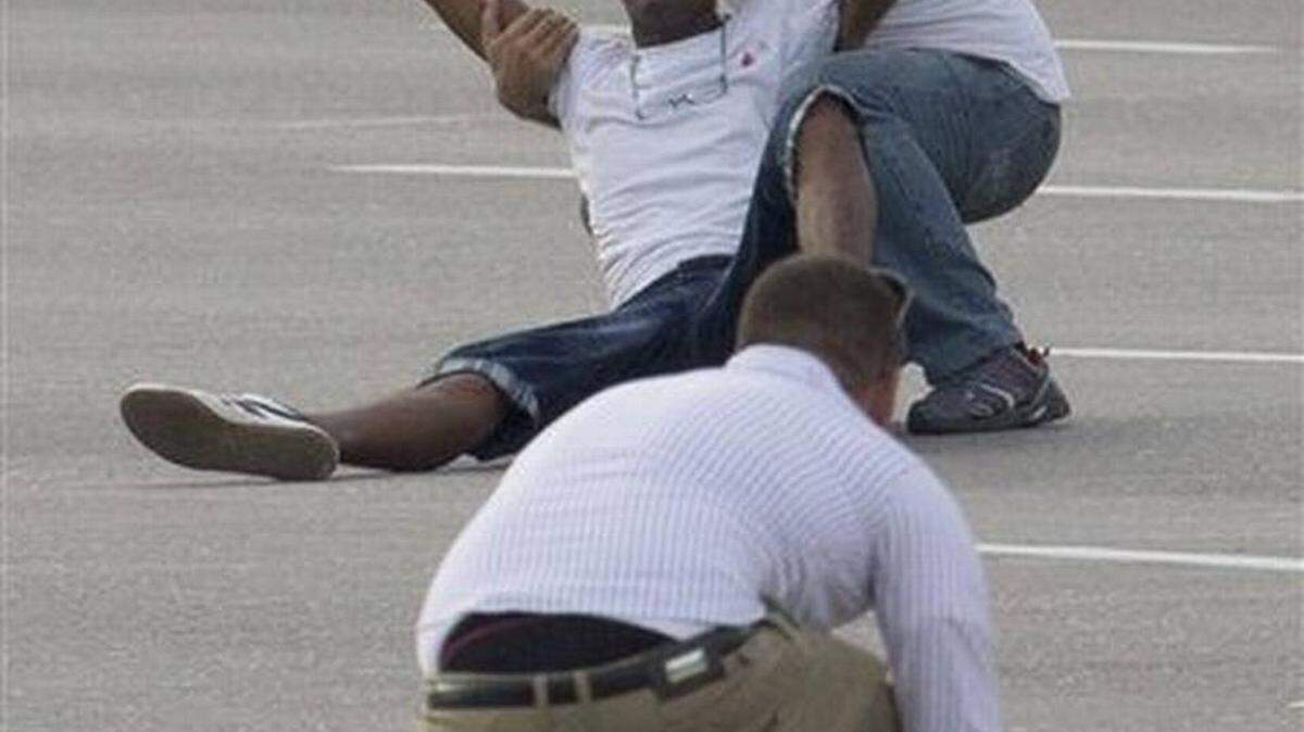 A man is grabbed by a Cuban security officer as another one collects leaflets they threw as Pope Francis was arriving for a Mass at Revolution Plaza in Havana. 
 Ramon Espinosa / AP