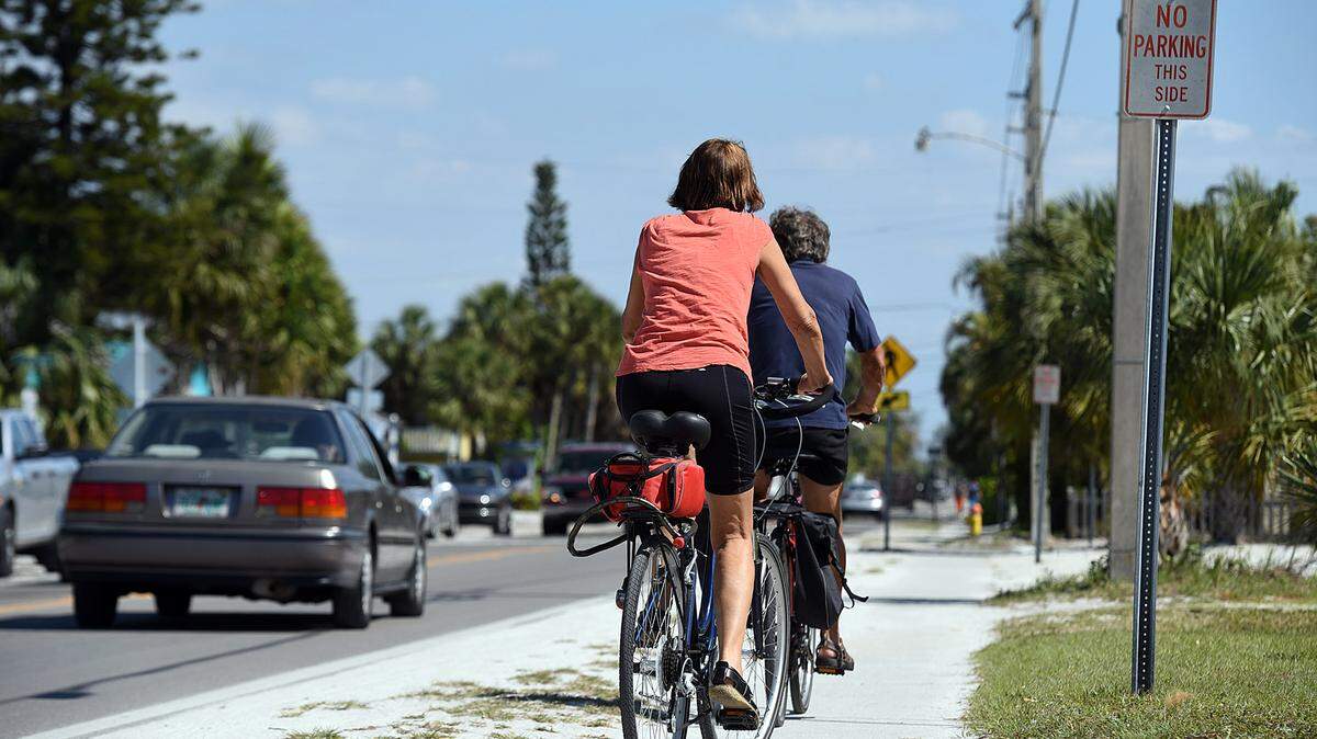 Cyclists ride on the sidewalk down Gulf Drive on the north end of Anna Maria Island Wednesday afternoon. Officials are discussing an islandwide bike path but plans are still developing and funding isn't secured yet.TIFFANY TOMPKINS/Bradenton Herald